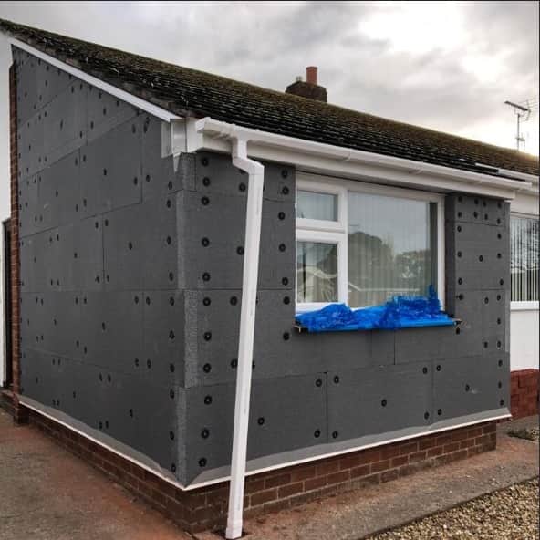Park home with dark grey external wall insulation boards and fixings fitted
